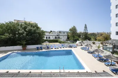a sauna with wooden walls and a bench in a room at Albufeira Olympics 1BR Apartment with Pool & Balcony, by Hopstays in Albufeira