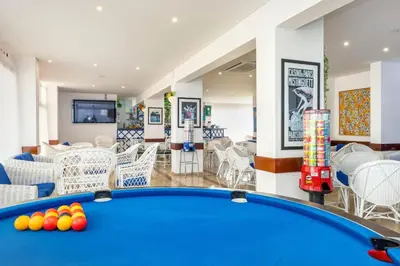 a pool table in the middle of a room at Albufeira Olympics 1BR Apartment with Pool & Balcony, by Hopstays in Albufeira