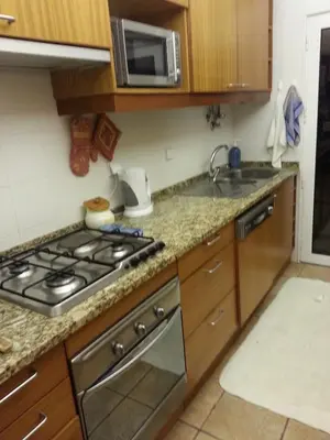 a kitchen with a stove and a sink at Villapinheiros in Vilamoura
