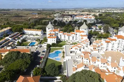 an aerial view of a town with white buildings at Vilamoura central by HD in Vilamoura