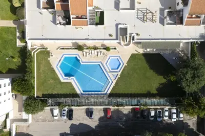 an overhead view of a swimming pool on top of a house at Vilamoura central by HD in Vilamoura