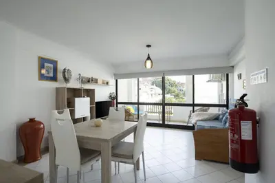 a living room with a table and chairs and a fire hydrant at Vilamoura central by HD in Vilamoura