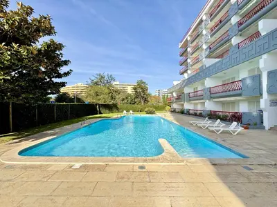 a swimming pool in front of a building at Vilamoura Marina Beach With Pool by Homing in Vilamoura