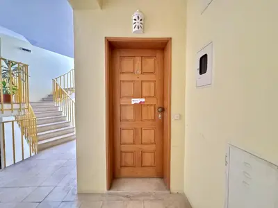 a wooden door in a building with stairs at Albufeira Vintage Apartment 2 With Pool by Homing in Albufeira