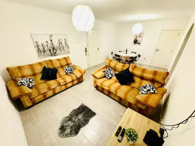 a living room with two couches and a table at Amazing Space - 4 Bedroom in Albufeira