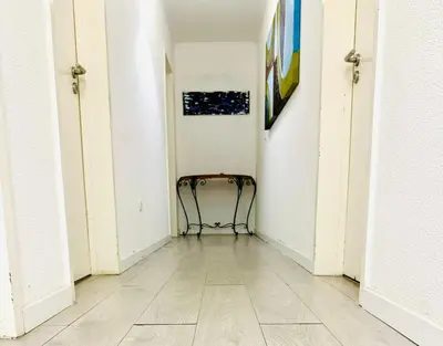 an empty hallway with a chair in a room at Amazing Space - 4 Bedroom in Albufeira