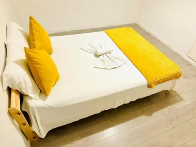 a white bed with yellow pillows and a yellow blanket at Amazing Space - 4 Bedroom in Albufeira