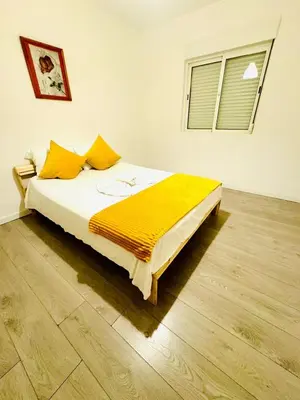 a bedroom with a bed with a yellow blanket on it at Amazing Space - 4 Bedroom in Albufeira