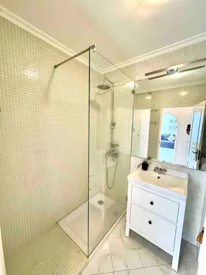 a bathroom with a shower and a sink and a mirror at Apartamento 5 estrelas praia da oura in Albufeira