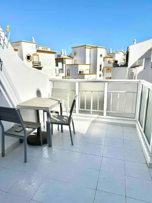 a patio with a table and chairs on a balcony at Apartamento 5 estrelas praia da oura in Albufeira