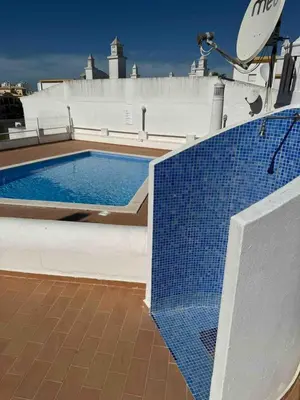 a swimming pool on the roof of a building at Apartamento 5 estrelas praia da oura in Albufeira