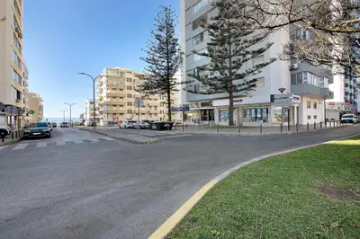 an empty street in a city with buildings at Delmar in Quarteira