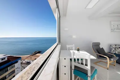 a room with a desk and a view of the ocean at Delmar in Quarteira