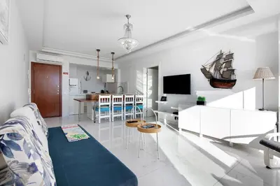 a living room with a sailboat on the wall at Delmar in Quarteira