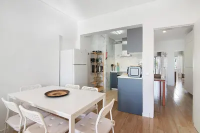 a white dining room with a white table and chairs at Abertura Mar Zen in Quarteira