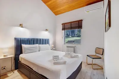 a bedroom with a large bed and a window at Bento Box Villa Family Hub Fitness in Vilamoura