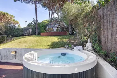 a hot tub in a garden with a gazebo at Bento Box Villa Family Hub Fitness in Vilamoura