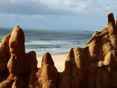 a sand sculpture of a rock on a beach at Pine Cliff Apartment by The Portuguese Butler in Olhos de Água