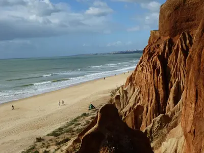 a view of a beach with people walking on the sand at Pine Cliff Apartment by The Portuguese Butler in Olhos de Água