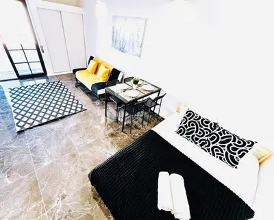 a living room with a couch and a table at Studio com vista para Rua da Oura - Albufeira in Albufeira