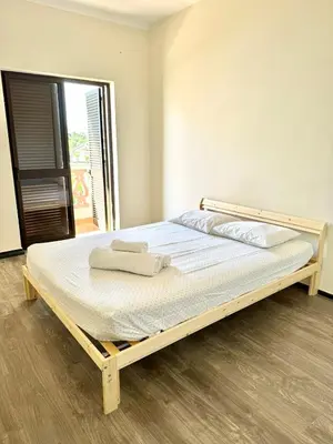 a bed in a room with a wooden frame at Fabulous Praia dos Pescadores in Albufeira