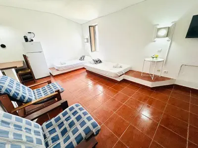 a living room with a couch and chairs in it at Apartamento aconchego T1 Rua da Oura in Albufeira