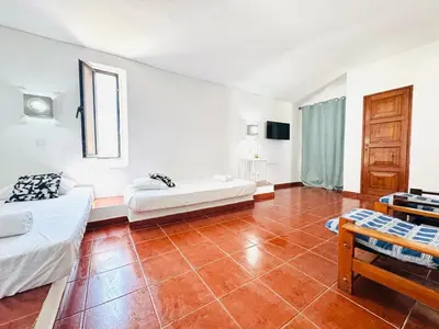 a large room with two beds and a table at Apartamento aconchego T1 Rua da Oura in Albufeira