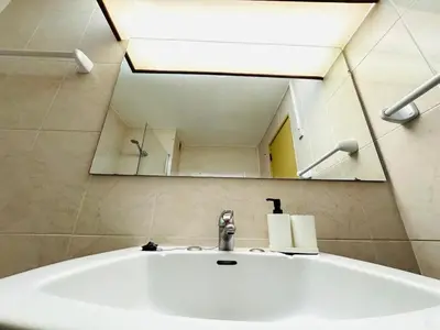 a bathroom sink with a large mirror above it at Condominio privado T1 Rua da Oura in Albufeira