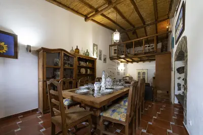 a dining room with a wooden table and chairs at Villa Monte Domingos Simoes in Albufeira