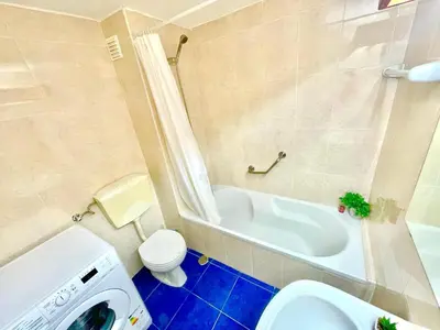 a bathroom with a tub and a toilet and a sink at Resort Albufeira T1, Oura Beach in Albufeira