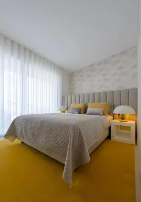 a bedroom with a large bed and a large window at Villa Clipper in Guia