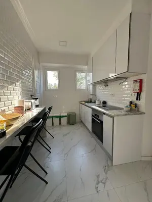 a kitchen with a counter top and a window at Casa das Oliveiras in Faro