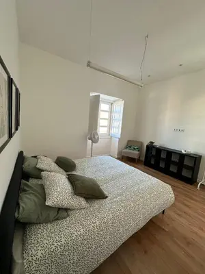 a bedroom with a bed with pillows on it at Casa das Oliveiras in Faro