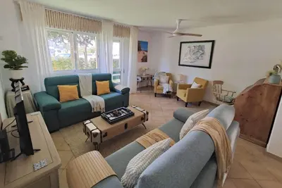 a living room with a blue couch and chairs at Boa Vida in Vilamoura