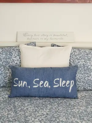 a bed with a pillow with a sign on it at Boa Vida in Vilamoura