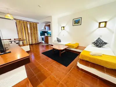 a hotel room with a bed and a desk at Resort Albufeira T1, Oura Beach in Albufeira