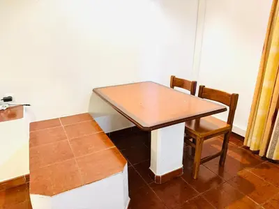 a table and a chair in a room at Resort Albufeira T1, Oura Beach in Albufeira