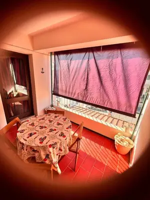 a table and chairs in a room with a large window at Red Apartament Praia da Oura in Albufeira