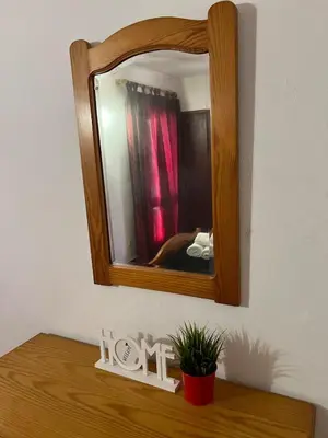 a mirror sitting on top of a wooden table at Red Apartament Praia da Oura in Albufeira