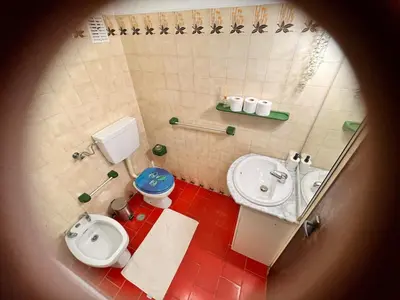 a small bathroom with a toilet and a sink at Red Apartament Praia da Oura in Albufeira