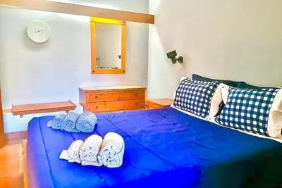 a bedroom with a blue bed with shoes on it at Resort Albufeira T2, Oura Beach in Albufeira
