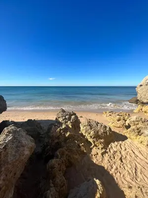 a beach with rocks and the ocean in the background at Resort Albufeira T2, Oura Beach in Albufeira