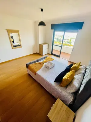 a bedroom with a couch with pillows on it at Duplex Apartment Albufeira in Albufeira