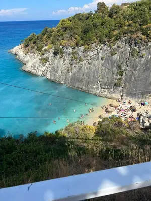 a view of a beach with people in the water at Duplex Apartment Albufeira in Albufeira