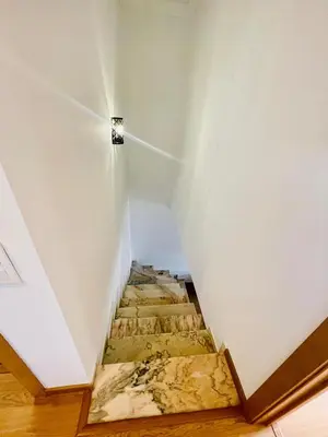 a stairwell with a painting on the wall at Duplex Apartment Albufeira in Albufeira