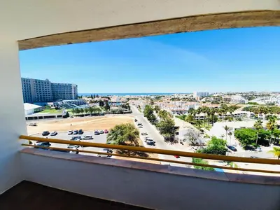 a large window with a view of a parking lot at Duplex Apartment Albufeira in Albufeira