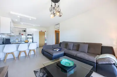 a living room with a couch and a table at Almargem Apartment in Quarteira