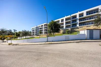 an empty street in front of a large building at Almargem Apartment in Quarteira