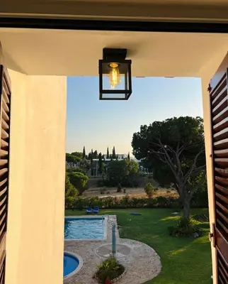 a view of a pool from a patio door at The Sun of Quarteira in Quarteira