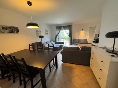 a kitchen and living room with a table and a couch at Lovely 3 Bedroom Home in a Resort in Albufeira in Albufeira